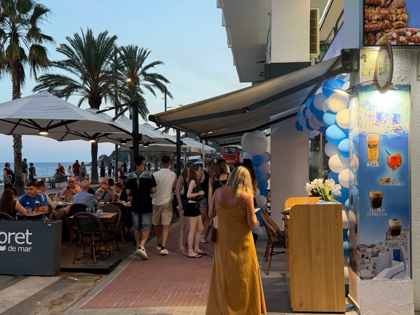 King Souvlaki seaside terrace on the Lloret de Mar promenade at sunset with palm trees